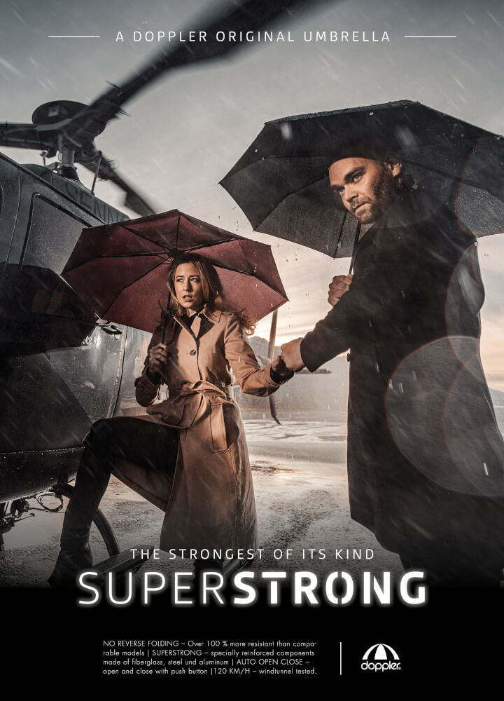 Produktplakat, zeigt zwei Menschen mit einem doppler SUPERSTRONG Regenschirm.